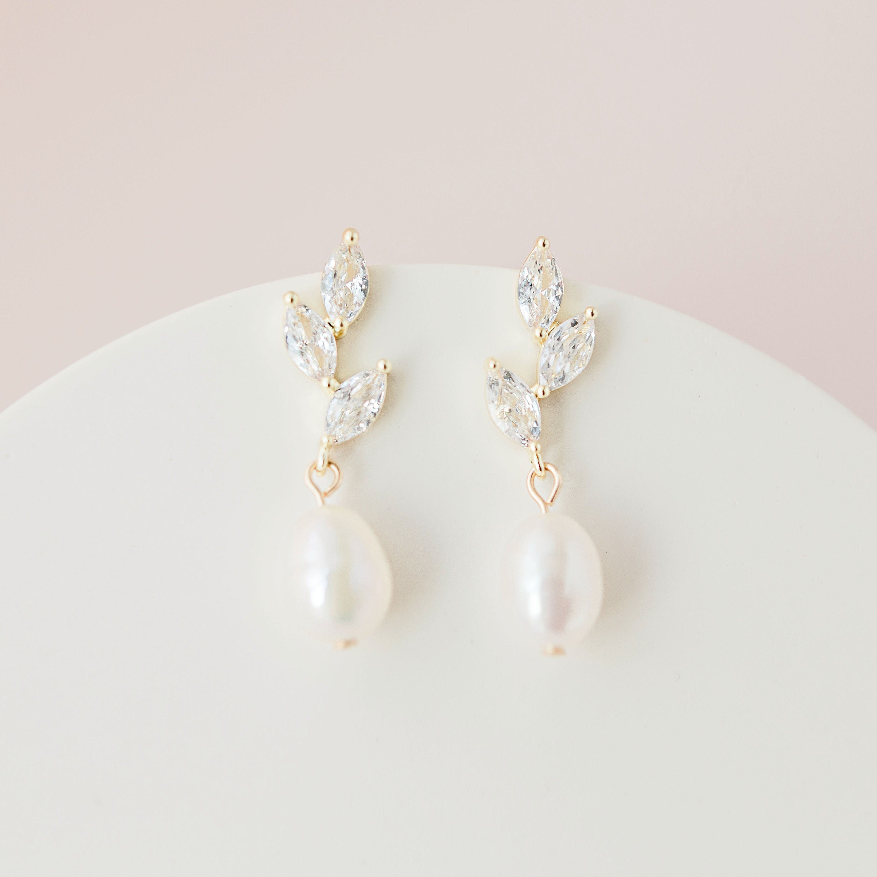 A pair of gold and pearl cubic zirconia dangle wedding earrings
